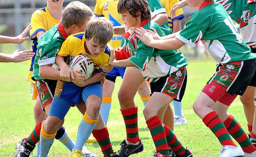 Lachlan Smith works hard to shrug off Hervey Bay defenders. Lachlan Smith works hard to shrug off Hervey Bay defenders.